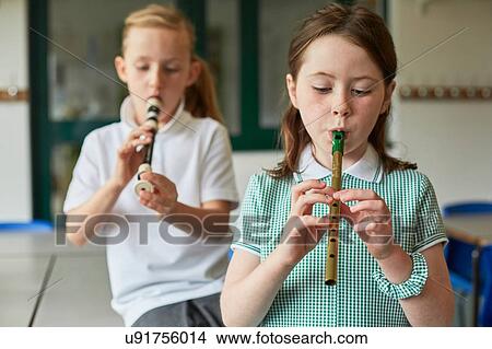 Schoolgirls playing recorders in classroom at primary school View Large Photo Image Picture - Schoolgirls playing recorders in classroom at primary school. Fotosearch