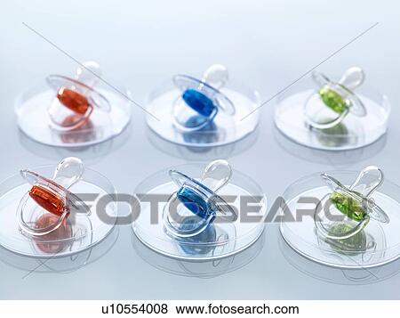 Stock Photo - Scientific Cloning, A series of modified babies illustrated by baby soothers in petri dishes. Fotosearch