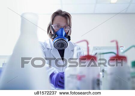 Scientist in breathing apparatus working in laboratory View Large Photo Image Stock Photo - Scientist in breathing apparatus working in laboratory. Fotosearch