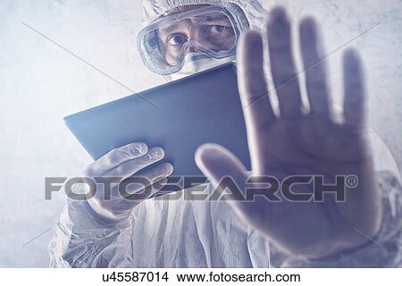 Scientist in protective suit with digital tablet. View Large Photo Image Picture - Scientist in protective suit with digital tablet.. Fotosearch