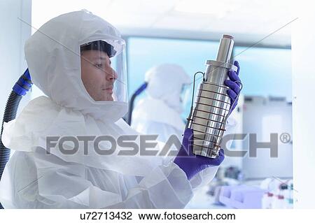 Scientist in protective wear inspecting filter in laboratory View Large Photo Image Stock Image - Scientist in protective wear inspecting filter in laboratory. Fotosearch