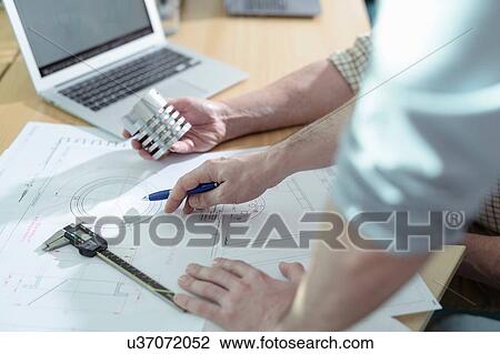 Scientists discussing engineering plans of science project in meeting room, close up View Large Photo Image Stock Image - Scientists discussing engineering plans of science project in meeting room, close up. Fotosearch
