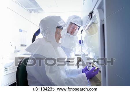 Stock Photography - Scientists working in protective wear in laboratory. Fotosearch