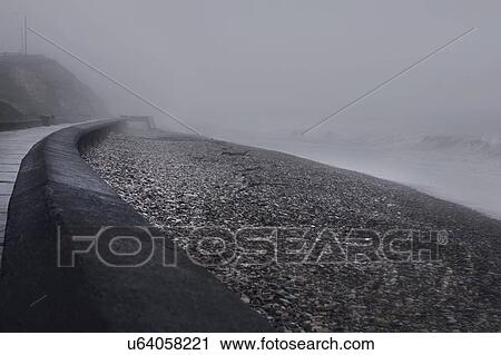 Stock Image - Sea wall in mist, Seaham Harbour, Durham, UK. Fotosearch