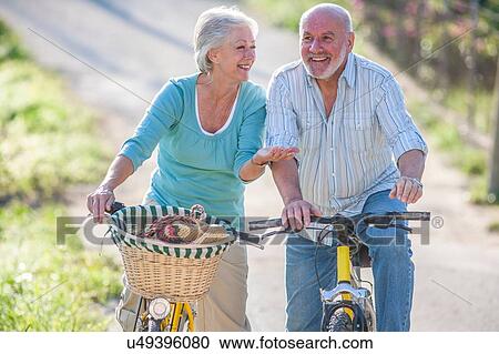 Stock Image - Senior couple riding bicycles. Fotosearch