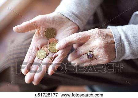Senior woman counting coins in hand, close-up View Large Photo Image Stock Photo - Senior woman counting coins in hand, close-up. Fotosearch