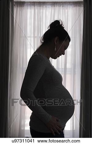 Silhouette of pregnant woman View Large Photo Image Stock Image - Silhouette of pregnant woman. Fotosearch