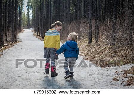 Sister leading little brother, Troll Falls, Canmore, Canada View Large Photo Image Stock Image - Sister leading little brother, Troll Falls, Canmore, Canada. Fotosearch