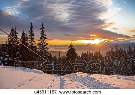Ski lift on snow covered landscape at sunset, Gurne, Ukraine, Eastern Europe View Large Photo Image Stock Photo - Ski lift on snow covered landscape at sunset, Gurne, Ukraine, Eastern Europe. Fotosearch