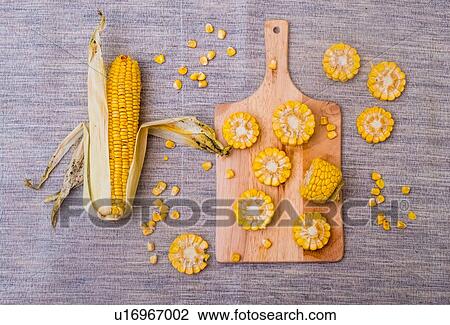 Sliced corn on the cob on chopping board, overhead view View Large Photo Image Stock Image - Sliced corn on the cob on chopping board, overhead view. Fotosearch
