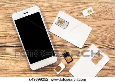 Stock Image - Smartphone with blank screen and SIM cards.. Fotosearch