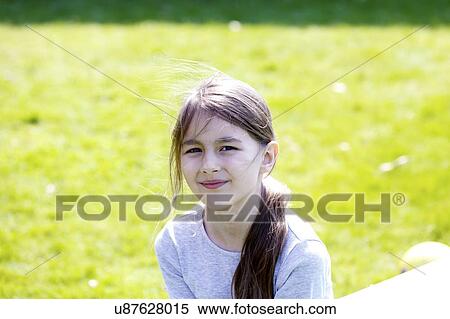 Stock Photography - Smiling girl in park.. Fotosearch