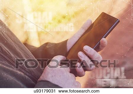 Stock Image - Social networking on mobile phone.. Fotosearch