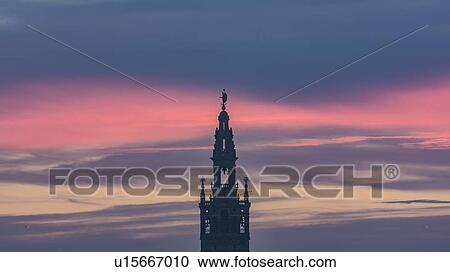 Stock Image - Spain, Andalusia, Seville, Bell tower of La Giralda against romantic sky. Fotosearch