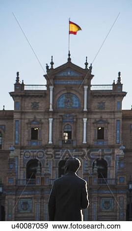 Stock Photo - Spain, Andalusia, Seville, Facade with spanish flag and statue of Anibal Gonzales in Plaza de Espana. Fotosearch