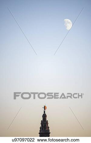 Stock Image - Spain, Andalusia, Seville, Moonrise over Giralda Tower. Fotosearch