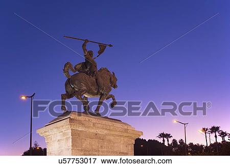 Stock Photo - Spain, Andalusia, Seville, Statue against clear sky at dusk. Fotosearch