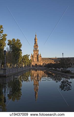 Spain, Andalusia, Seville, Tower in Plaza de Espana reflected in water View Large Photo Image Stock Photo - Spain, Andalusia, Seville, Tower in Plaza de Espana reflected in water. Fotosearch