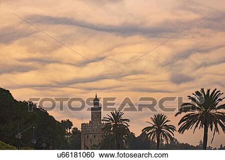 Stock Image - Spain, Seville, Torre del Oro, Unusual cloud formation at dawn. Fotosearch