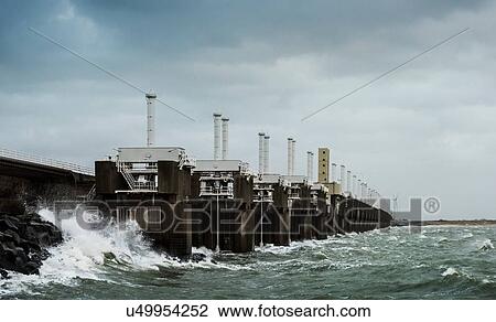 Steel valves at Neeltje-Jans Oosterschelde flood barrier closed to protect the Netherlands during a storm View Large Photo Image Stock Image - Steel valves at Neeltje-Jans Oosterschelde flood barrier closed to protect the Netherlands during a storm. Fotosearch