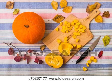 Still life of pumpkin, chopping board and chopped pumpkin, overhead view View Large Photo Image Stock Photo - Still life of pumpkin, chopping board and chopped pumpkin, overhead view. Fotosearch