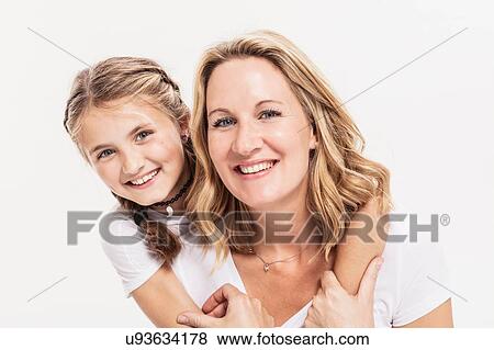 Studio portrait of girl with arms around her mother, head and shoulders View Large Photo Image Stock Photo - Studio portrait of girl with arms around her mother, head and shoulders. Fotosearch