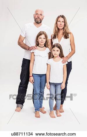 Picture - Studio portrait of mature couple with two daughters, full length. Fotosearch