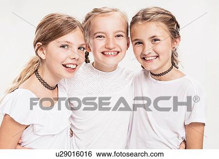 Studio portrait of three girls with blond hair, waist up View Large Photo Image Stock Photograph - Studio portrait of three girls with blond hair, waist up. Fotosearch