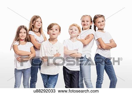 Stock Image - Studio portrait of two boys and four girls posing with arms folded. Fotosearch