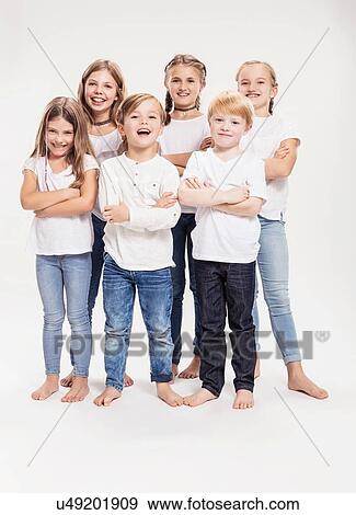 Studio portrait of two boys and four girls with arms folded, full length View Large Photo Image Stock Photo - Studio portrait of two boys and four girls with arms folded, full length. Fotosearch