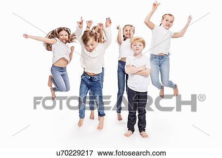 Stock Photo - Studio portrait of two boys and four girls having fun jumping mid air, full length. Fotosearch