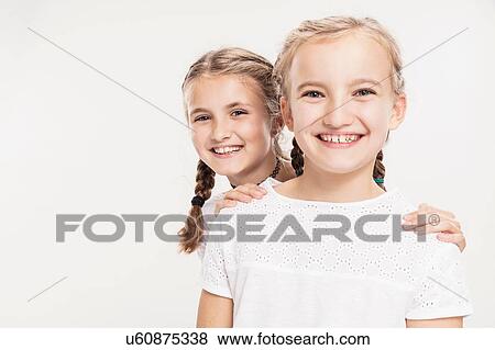 Studio portrait of two smiling girls, head and shoulders View Large Photo Image Stock Photo - Studio portrait of two smiling girls, head and shoulders. Fotosearch
