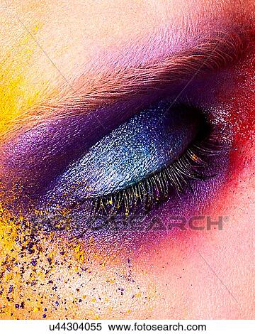 Studio shot of young woman's eye with multi coloured powder eye shadow, close up View Large Photo Image Stock Photography - Studio shot of young woman's eye with multi coloured powder eye shadow, close up. Fotosearch