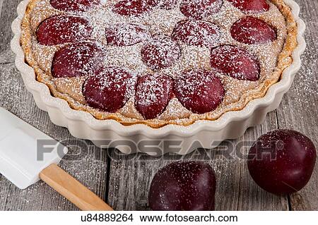 Sugar dusted plum and cinnamon tart View Large Photo Image Picture - Sugar dusted plum and cinnamon tart. Fotosearch
