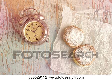 Sugary donuts and vintage clock on rustic table. View Large Photo Image Stock Image - Sugary donuts and vintage clock on rustic table.. Fotosearch