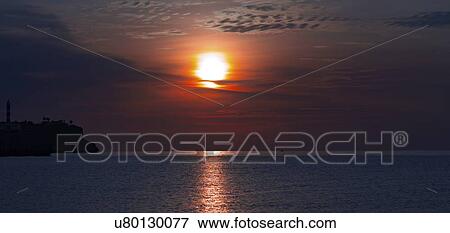 Sun setting over the sea. View Large Photo Image Stock Photo - Sun setting over the sea.. Fotosearch