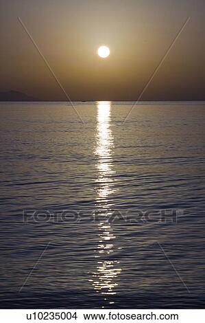 Sunset over calm sea. View Large Photo Image Picture - Sunset over calm sea.. Fotosearch