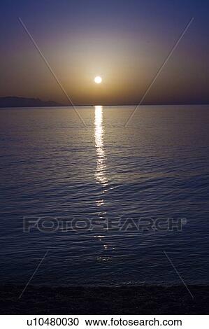 Sunset over calm sea. View Large Photo Image Stock Image - Sunset over calm sea.. Fotosearch