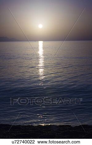Sunset over calm sea. View Large Photo Image Stock Image - Sunset over calm sea.. Fotosearch