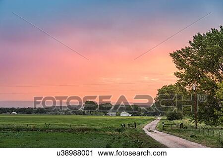 Stock Image - Sunset over rural landscape, Montana, US. Fotosearch