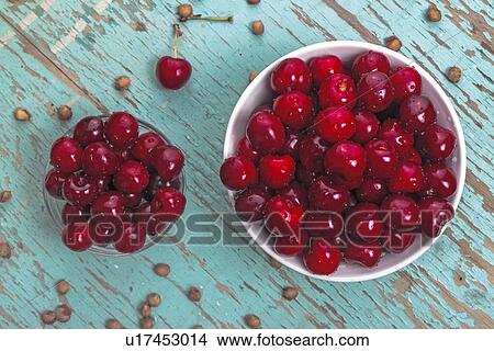 Sweet cherries in bowls on rustic table. View Large Photo Image Picture - Sweet cherries in bowls on rustic table.. Fotosearch