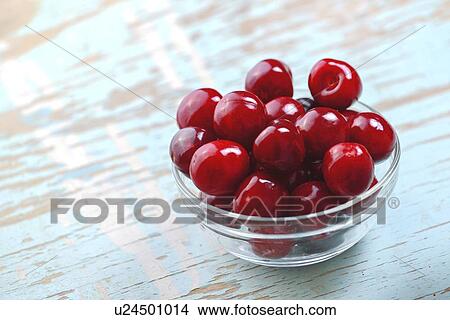 Sweet cherries in glass bowl on rustic table. View Large Photo Image Picture - Sweet cherries in glass bowl on rustic table.. Fotosearch