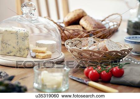 Table with fresh bread, cheeses and vine tomatoes View Large Photo Image Stock Image - Table with fresh bread, cheeses and vine tomatoes. Fotosearch