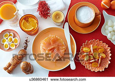 Stock Image - Table with fresh salmon, boiled eggs and tomatoes. Fotosearch