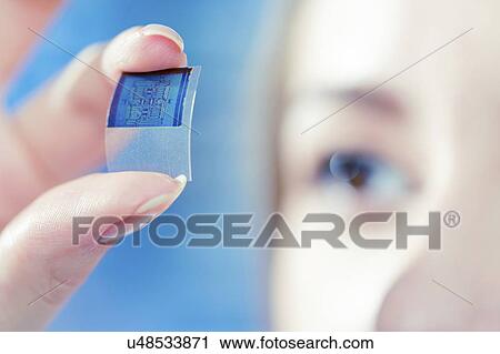 Technician examining microchip in microelectronics laboratory. View Large Photo Image Stock Image - Technician examining microchip in microelectronics laboratory.. Fotosearch