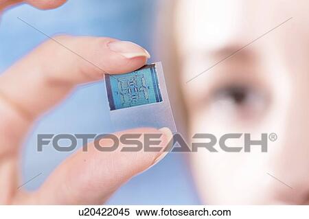 Technician examining microchip in microelectronics laboratory. View Large Photo Image Stock Photography - Technician examining microchip in microelectronics laboratory.. Fotosearch
