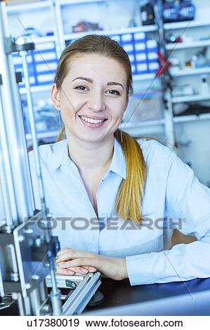 Stock Photo - Technician in front of 3d printer.. Fotosearch