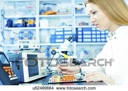 Picture - Technician testing circuit in microelectronics laboratory.. Fotosearch