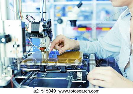 Stock Photo - Technician using 3d printer.. Fotosearch