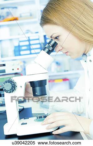 Technician using microscope to examine microelectronics. View Large Photo Image Stock Photography - Technician using microscope to examine microelectronics.. Fotosearch